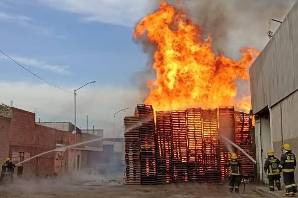 Voraz incendio consume bodegas de tarimas y 6 vehículos frente a Central de Abasto de Puebla